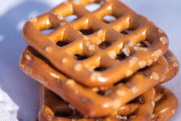 A grouping of pretzels coated with dark and light chocolate on a white background.