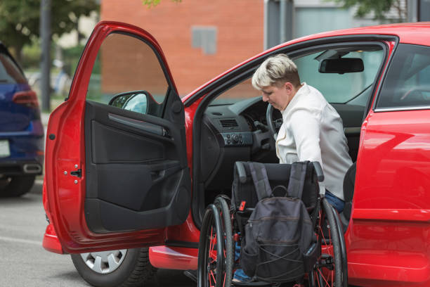 istock Female driver entering a car, a wheelchair user on the way to work 2204360767