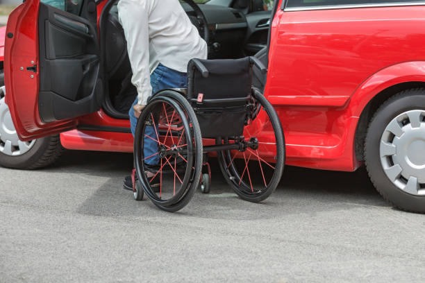 istock Businesswoman, a driver with a disability getting into a red car 2204360845