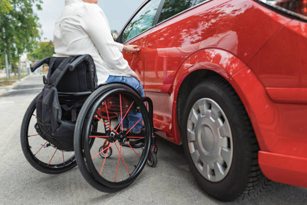 istock Female driver entering a car, a wheelchair user on the way to work 2204360962