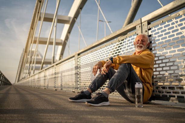istock Senior man resting after exercising on a bridge 2204361320