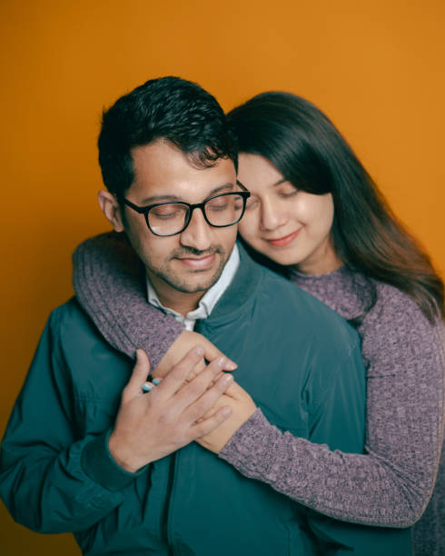 Asian - Nepali Couple - Studio Portraits - Yellow Background - Hugging