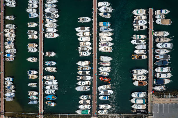 Aerial view of a Mediterranean, French marina with white yachts, sailboats and motorboats.