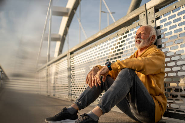 istock Senior man resting after exercising on a bridge 2204361580