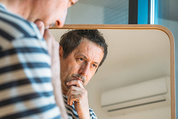 istock Worried concerned man in front of the mirror 2204362014