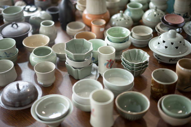 istock Ceramic cups and bowls on the table in the pottery studio 2204362353