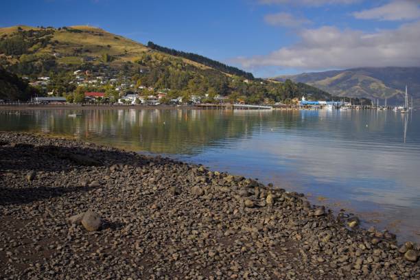 istock Serene Bay View with Rocky Shoreline and Green Hills 2204362802