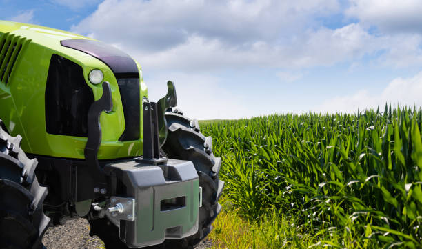 istock Green tractor on a agricultural field 2204362902