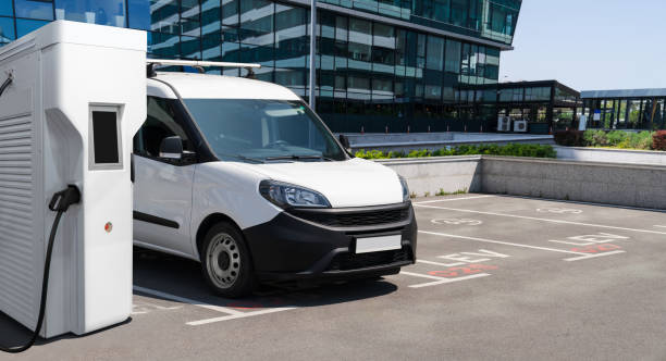 istock Electric delivery van with electric vehicles charging station 2204363766