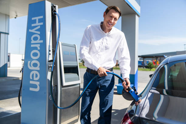 istock Man holds a hydrogen fueling nozzle on a hydrogen filling station 2204363988
