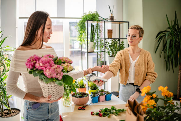 istock Paying with wireless technology for flowers at a modern florist shop 2204364138