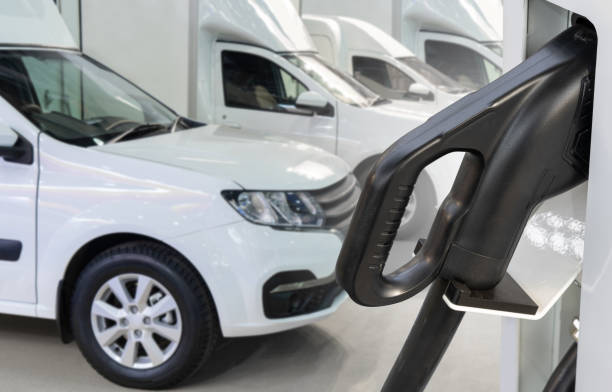 istock Electric delivery van with electric vehicles charging station 2204364301