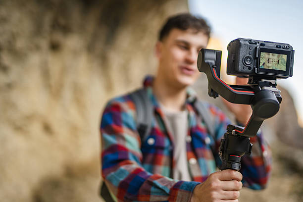 istock close up on male hands hold camera with stabilizer and filming 2204365660