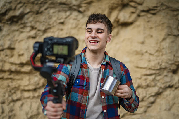 istock Man hiker making video on camera with stabilizer show cup on footpath 2204365673