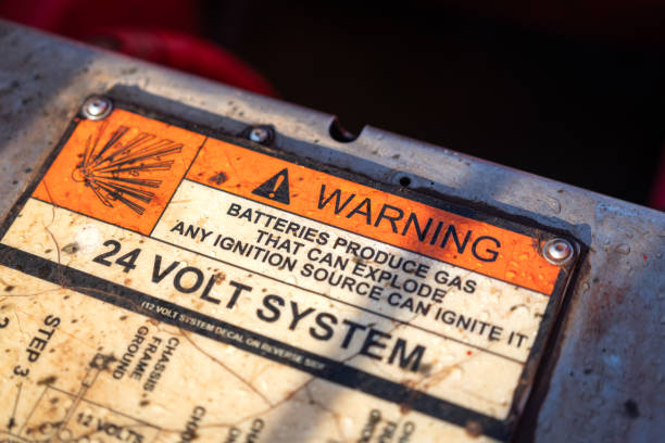 istock Warning sign of batteries 24 voltage system on the electronic equipment. 2204365827