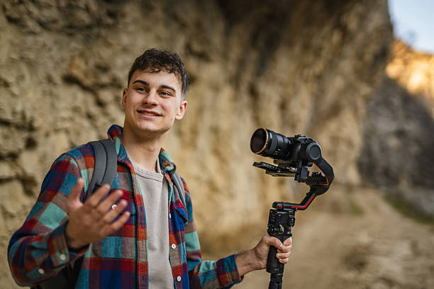 istock Man hiker making video on camera with stabilizer in front rocks 2204365828