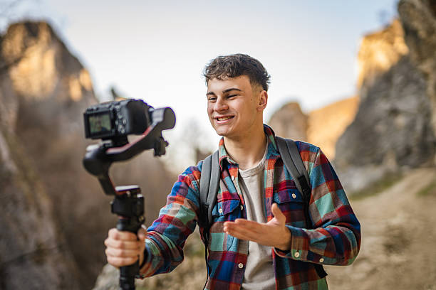 istock Man hiker making video on camera with stabilizer on footpath 2204366058