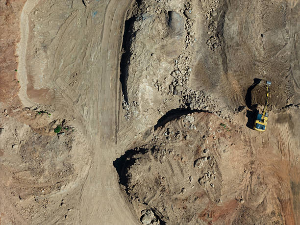 istock Construction site with heavy machinery at work during daylight hours in open terrain 2204366873