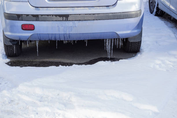 istock Icicles hang from the car body. There is snow on the ground 2204367694