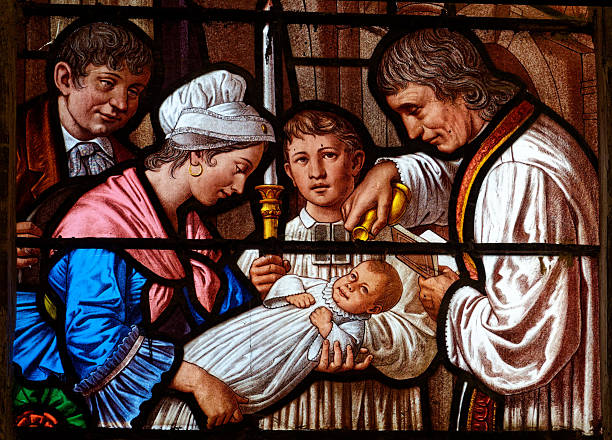 Église Saint Thibault - Joigny, FRANCE - 01-28-2025: Stained glass (19th century) of a Baptism.
