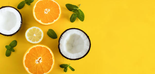 Tropical fruits on the yellow background. Copy space. Top view. Close-up.