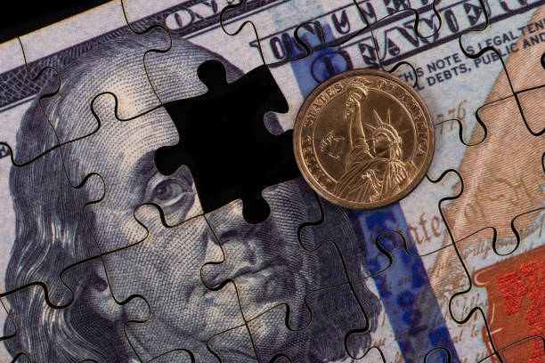 istock US $1 coin and US $100 bill made from puzzles 2204371384