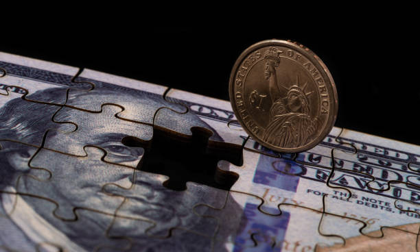 istock US $1 coin and US $100 bill made from puzzles 2204371417