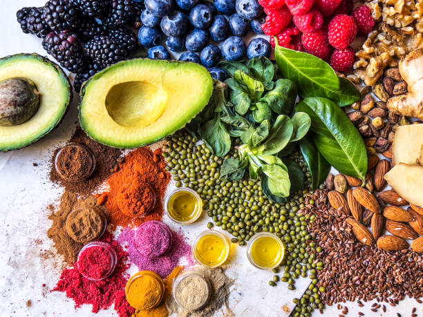 istock Multi colored vegetables, fruits, legumes, nuts and spices on wooden table 2204376807