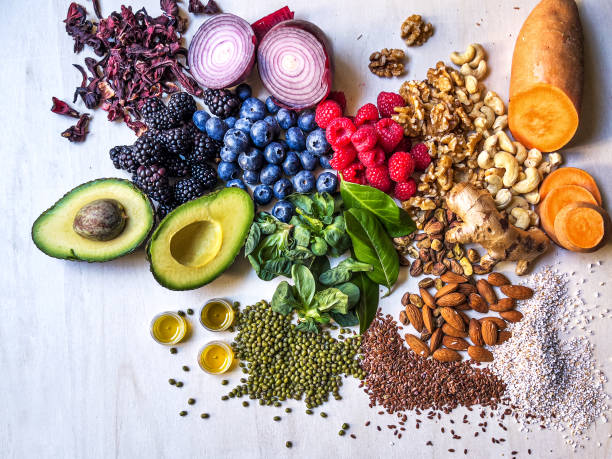 istock Multi colored vegetables, fruits, legumes and nuts on wooden table 2204376826