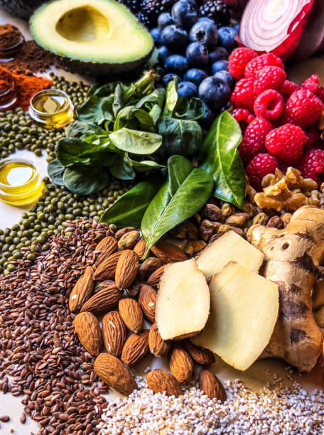 istock Multi colored vegetables, fruits, legumes and nuts on wooden table 2204376975