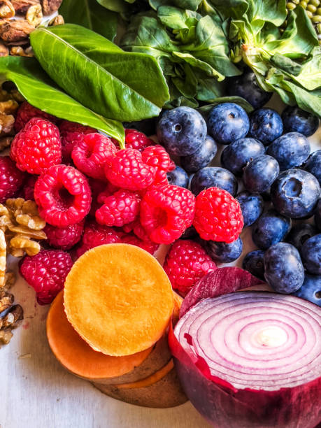 Multi colored vegetables,fruits, legumes and nuts on wooden table