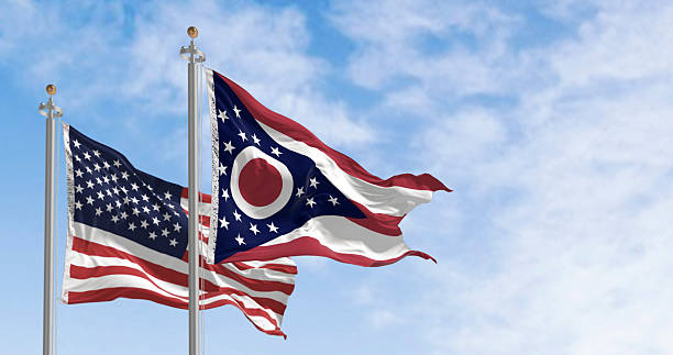 istock Ohio and national US flags waving in the wind on a clear day 2204380977