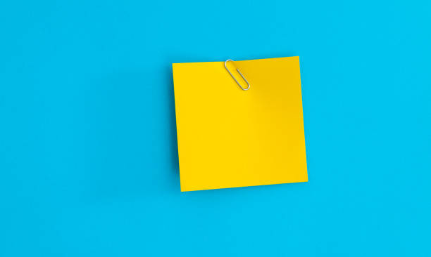 istock Note paper with paper clip on blue background 2204381692