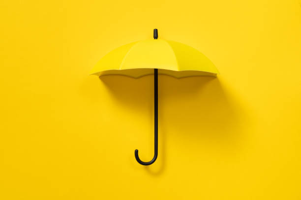 istock Yellow umbrella isolated on yellow background 2204383598