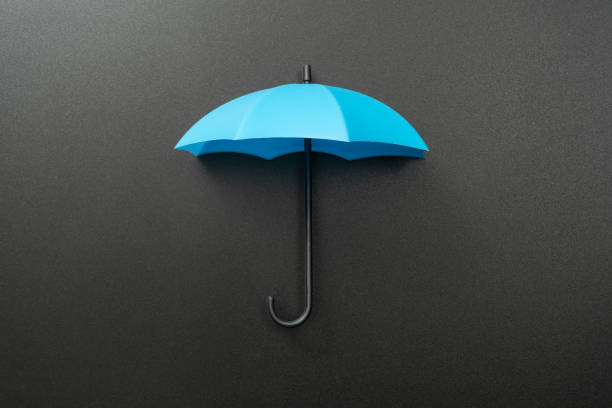 istock Blue umbrella isolated on black background 2204383734