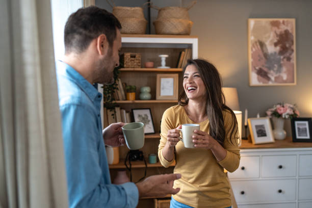 istock Happy young couple enjoying coffee and conversation at home 2204384393