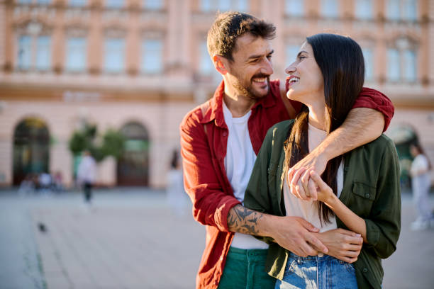 istock Happy couple embracing in a city square 2204387154