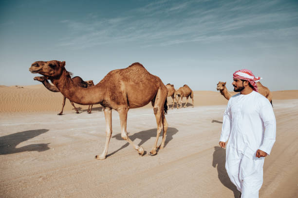 istock arab man walking in the desert 2204387310