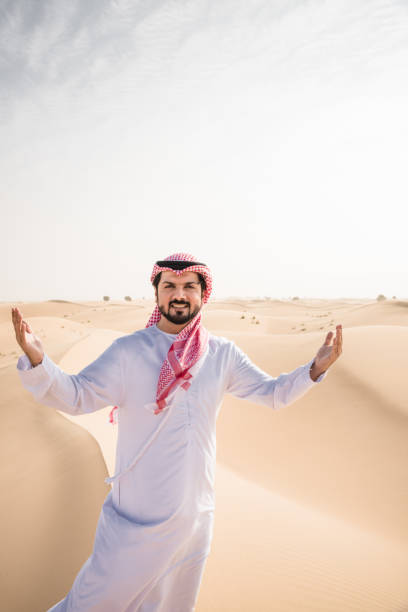istock arabic man walking in the desert 2204387803