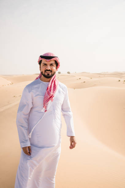 istock arabic man walking in the desert 2204387820