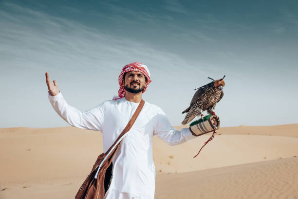 istock arab man with falcon in the desert 2204387887