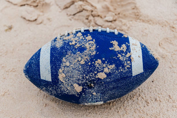 istock Rugby ball on the beach 2204390200