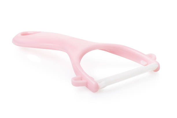 istock A pink plastic vegetable peeler for children isolated on white background 2204393063