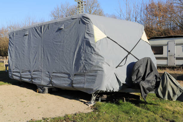 istock a caravan with a gray tarpaulin 2204393330