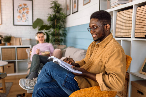 istock Students relaxing and listening to the music while doing a home tasks. 2204393391