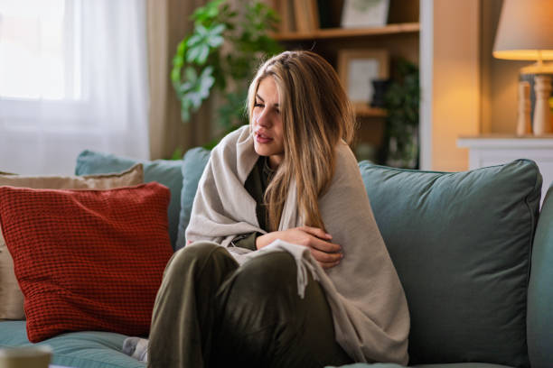 istock Woman in pain at home 2204394524