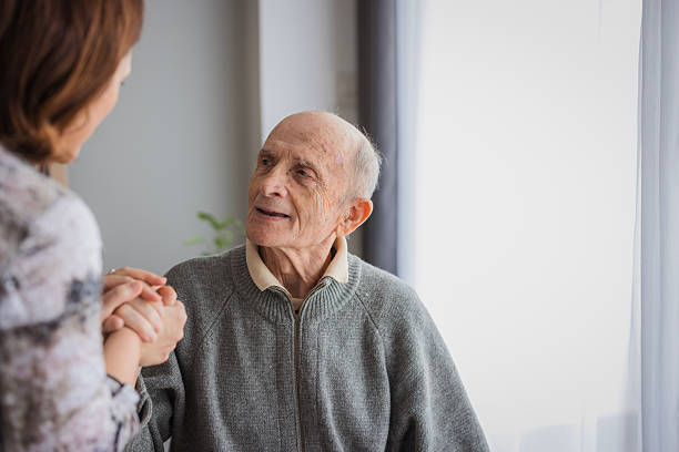 istock Elderly man holding his daughter's hand 2204395082