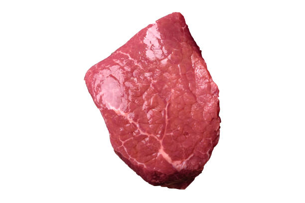 Raw beef tenderloin ribeye steak with salt and spices on a white background