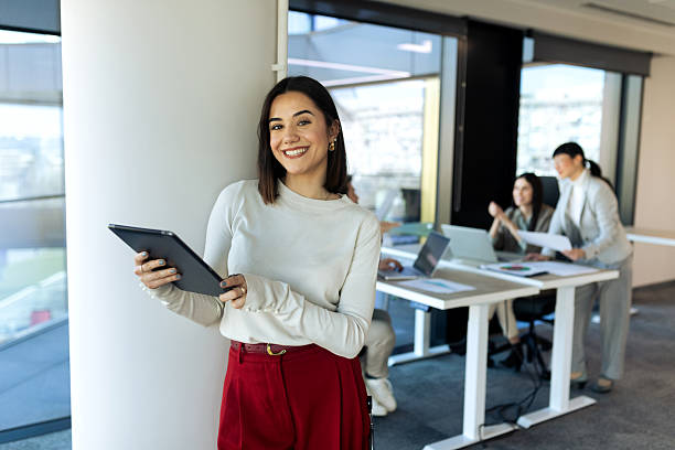 istock Successful business team working inside modern office on their laptop and discussing 2204403999
