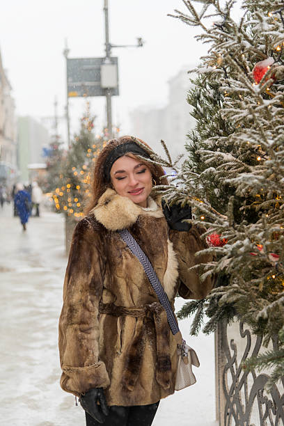 istock Woman enjoying a winter outing surrounded by festive decorations 2204404200